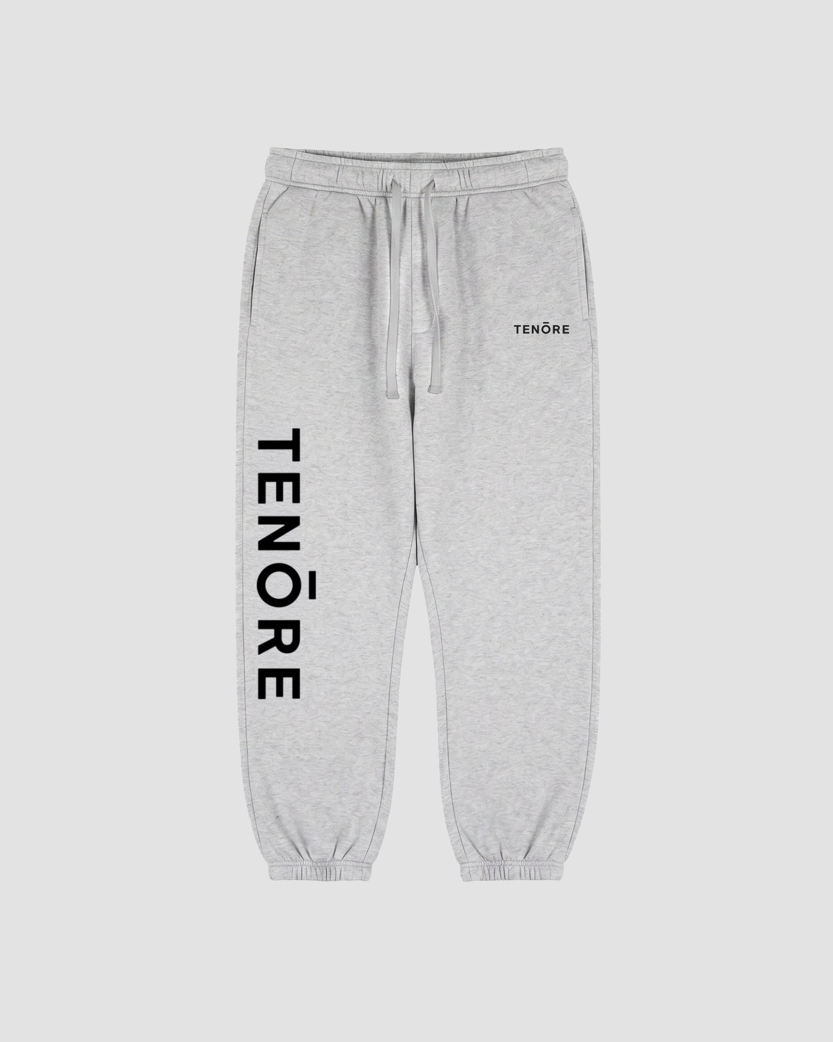 Light heather gray sweatpants with a black vertical TENORE logo printed on the left leg and a small black TENØRE logo on the right hip.